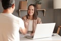 Indoor shot of business people shaking hands after meeting, sitting at table in office, being ready to sign contract, smiling Royalty Free Stock Photo