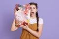 Indoor shot of creative young woman painting in her studio. Female artist in her workshop holding colors palette near her face, Royalty Free Stock Photo