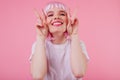 Indoor shot of lovely european woman fooling around on pink background. Studio photo of spectacular