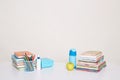 Indoor shot of school supplies: books, pen holder, fresh apple, bottle of water, pens, pencils, working area for little students, Royalty Free Stock Photo