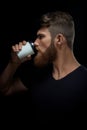 Brutal bearded man drinking coffee to go