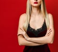 Indoor shot of serious strict young female dressed velvet dress keeping arms folded