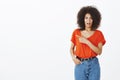 Indoor shot of shocked displeased good-looking female with curly hair, frowning and expressing dislike and antipathy