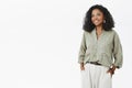 Indoor shot of successful good-looking african american female entrepreneur and mom standing in stylish hucky shirt and Royalty Free Stock Photo