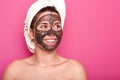 Indoor shot of young attractive woman with white towel on her head, has naked body, smilling isolated over pink background in Royalty Free Stock Photo