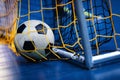 Indoor Soccer Futsal Ball On Goal With Net And Blue Background. Indoor Football Background Royalty Free Stock Photo