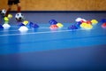 Indoor soccer player on training during the winter. Futsal training field with blue cones