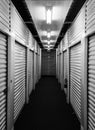 Metal self storage unit doors on each side of a hallway. Royalty Free Stock Photo
