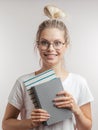 Portrait of young student girl with books isolated over grey wall background Royalty Free Stock Photo