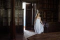 Indoor summer portrait of young pretty cute girl. Beautiful woman posing beside fairytale door inside wood cabinet, scars old cast