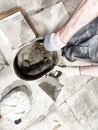Indoor tile repair and installation process with worker mixing concrete Royalty Free Stock Photo