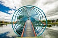 Indoor view of the colorful bridge over an artificial lake located in the midle of a park with the reflection in the Royalty Free Stock Photo