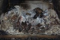 Cold fireplace in the living room with many ash and black soot and dirty interior bricks close-up Royalty Free Stock Photo