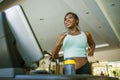 Indoors fitness lifestyle  portrait of young attractive and happy black afro American woman training hard at gym all sweaty doing Royalty Free Stock Photo