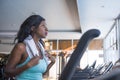 Indoors gym portrait of young attractive and beautiful black afro American sporty woman training treadmill running workout at fitn Royalty Free Stock Photo
