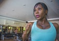 Indoors gym portrait of young attractive black afro American woman training hard all sweaty at fitness club a treadmill running wo Royalty Free Stock Photo