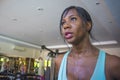 Indoors gym portrait of young attractive black afro American woman training hard all sweaty at fitness club a treadmill running wo Royalty Free Stock Photo