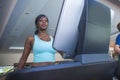 Indoors gym portrait of young attractive and sweaty black afro American sporty woman training treadmill running and walking workou Royalty Free Stock Photo