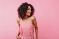 Indoors portrait of happy attractive girl with snow-white smile. Woman in pink summer dress posing Royalty Free Stock Photo