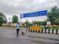 Indore, India - August 22nd 2020: Municipality Worker cleaning road outside Indore Airport. Cleanest city in India 2020