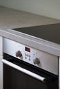 Induction hob and built-in electric oven at modern kitchen Royalty Free Stock Photo