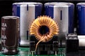 Inductor against the background of capacitors close-up