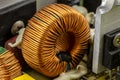 An inductor, toroidal coil on a ring with visible copper scroll, wound on a magnetic coil. Royalty Free Stock Photo