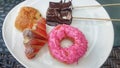 a white plate topped with donuts and pastries