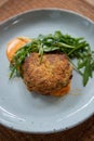 Crab Cake Dinner Recipe: Savor the Delight of Succulent Crab Cakes, Served with a Refreshing Rocket Salad Royalty Free Stock Photo