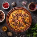 Colorful and fragrant bowl of Tajikistan& x27;s signature rice pilaf, Osh, with tender pieces of lamb or beef