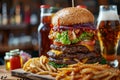 Gourmet burger tower with fries and craft beer on rustic wooden table Royalty Free Stock Photo