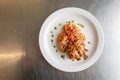 A Taste of Culinary Excellence: Spaghetti and Roast Chicken Delight Presented on a White Plate Royalty Free Stock Photo