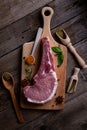 Indulge in the rustic charm of a raw piece of pork loin on a wooden board