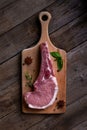 Indulge in the rustic charm of a raw piece of pork loin on a wooden board