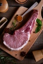 Indulge in the rustic charm of a raw piece of pork loin on a wooden board