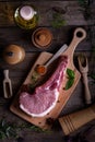 Indulge in the rustic charm of a raw piece of pork loin on a wooden board