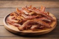 Cooked Greasy Bacon on a wood plate