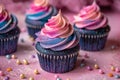 Galaxy-themed cupcakes with vibrant cosmic colors on a pink backdrop