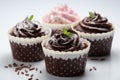 Indulgent chocolate cakes nestled in a cup, set against a pure white canvas