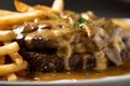 indulgent close-up of steak frites, with a perfectly cooked medium-rare steak on top of crispy fries