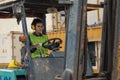 Industial background of african american container yard and cargo worker driving forklift a loading area