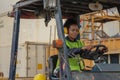 Industial background of african american container yard and cargo worker driving forklift a loading area