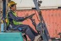 Industial background of african american forklift driver driving forklift a loading area at containers yard and cargo Royalty Free Stock Photo