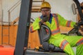 Industial background of african american forklift driver driving forklift a loading area at containers yard and cargo Royalty Free Stock Photo