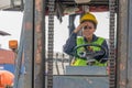 Industial background of african american forklift driver driving forklift a loading area at containers yard and cargo Royalty Free Stock Photo