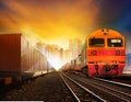 Industindustries container trainst and boxcar on track against b