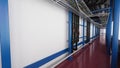 Industiral white wall and blue structure long corridor in daylight Royalty Free Stock Photo