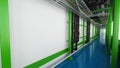 Industiral white wall and green structure long corridor in daylight