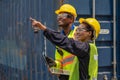 Industrail background of african american containers yard and cargo inspector team working at containers loading area