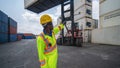 Industrail background of african american containers yard and cargo inspector working at containers loading area Royalty Free Stock Photo